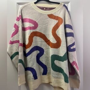 Cream sweater with multi color design